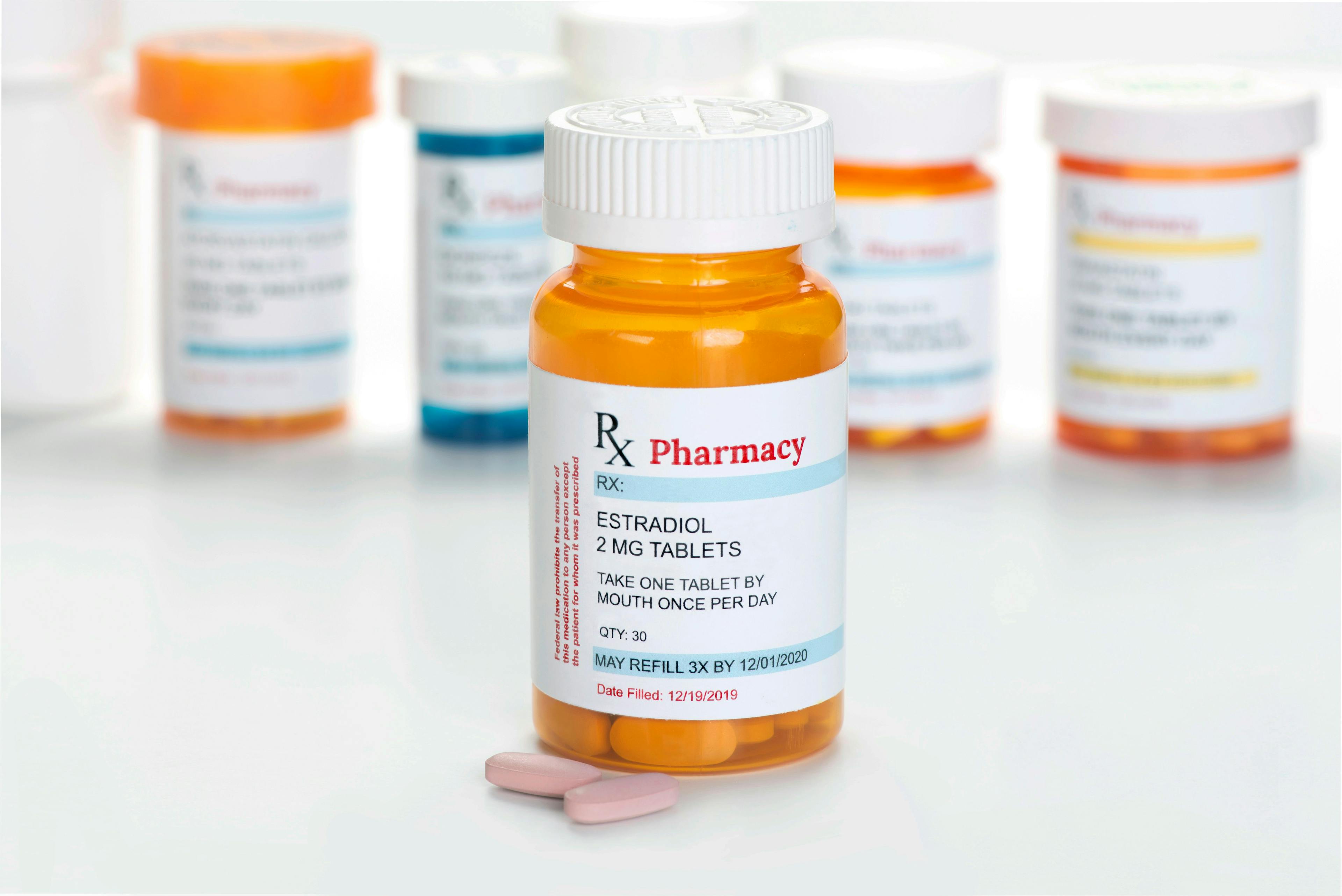 Estradiol generic estrogen Prescription Medicine Container with other prescription medication bottles in background | Image Credit: © Sherry Young - stock.adobe.com