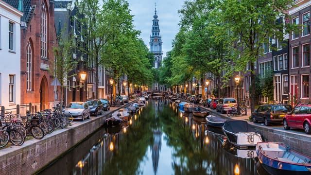 Amsterdam City, Illuminated Building and Canal at night, Netherlands | Image Credit: © gnoparus - stock.adobe.com