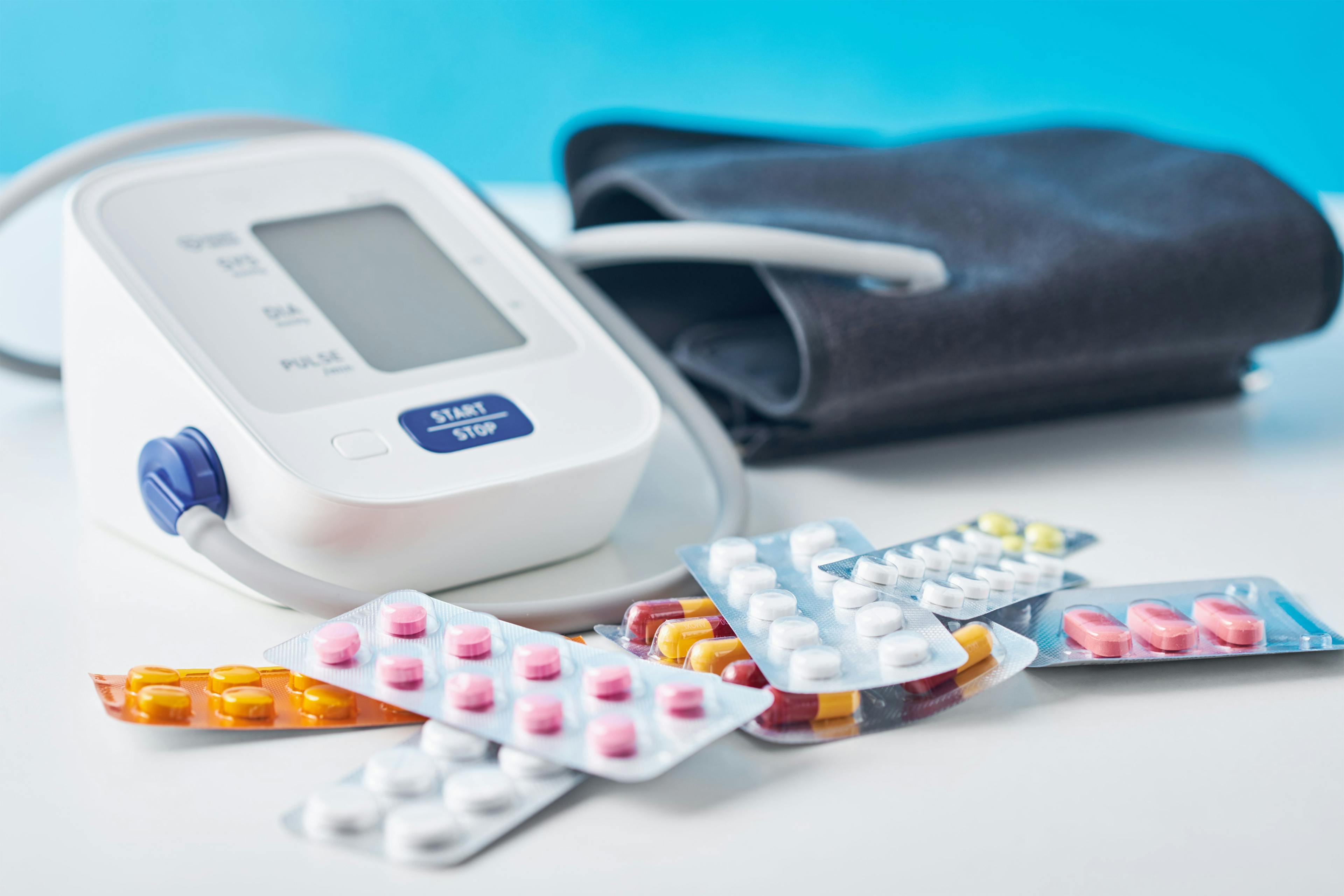 Digital blood pressure monitor and medical pills on the white table. Healthcare and medicine concept | Image Credit: ©Lazy_Bear - stock.adobe.com