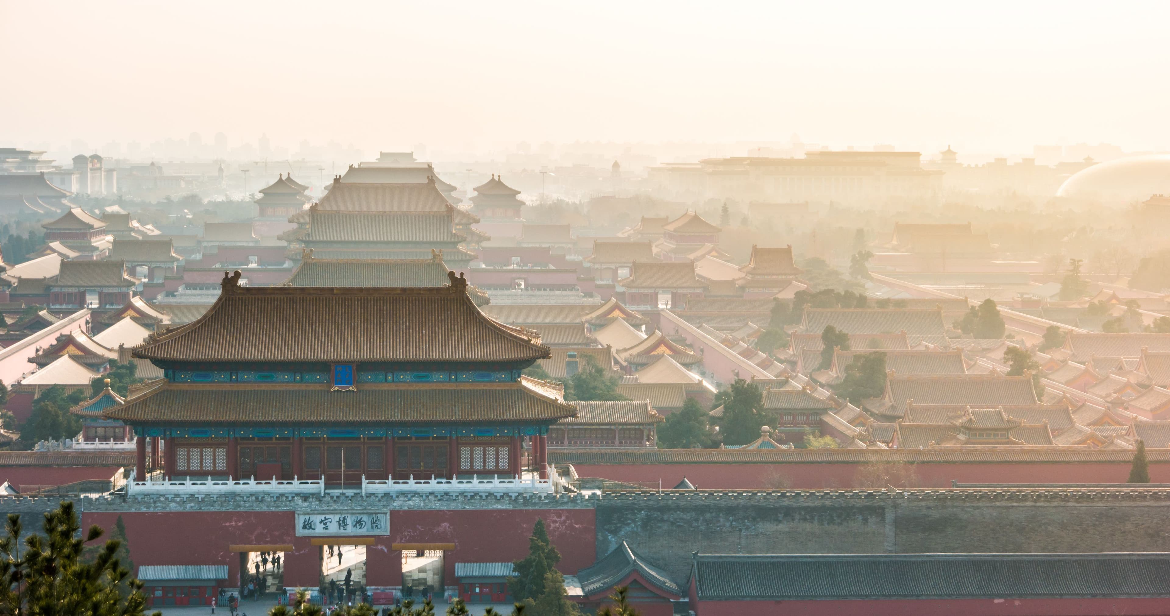 An aerial bird view of the the famous Forbidden City in Beijing, China. The vast area of the architectural complex is covered with evening mist. | Image Credit: © romas_ph - stock.adobe.com